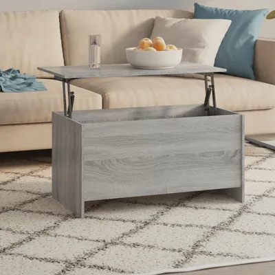 A lift-top coffee table with storage is shown in a living room setting, placed on a patterned rug in front of a sofa.