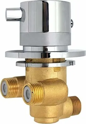 A close-up studio shot of a brass and chrome shower valve.