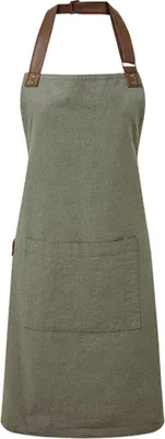 A plain studio shot of a green apron with brown leather straps.