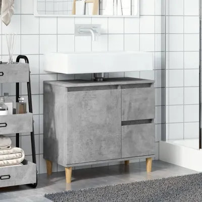 A bathroom vanity with a sink and a mirror above it, in a modern style with a concrete-like finish.