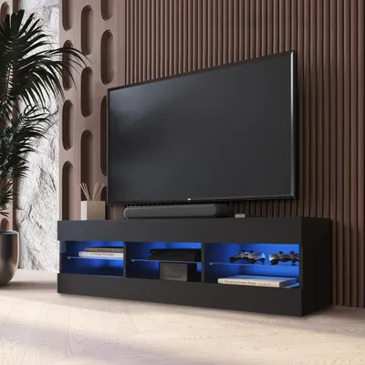 A modern living room setup featuring a black TV stand with blue LED lighting, a television, and a soundbar.
