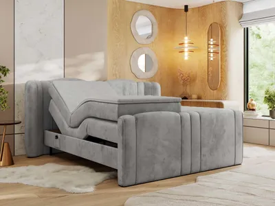 A modern bedroom with a grey upholstered adjustable bed.