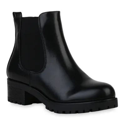 A black Chelsea boot with a platform sole is shown against a white background.