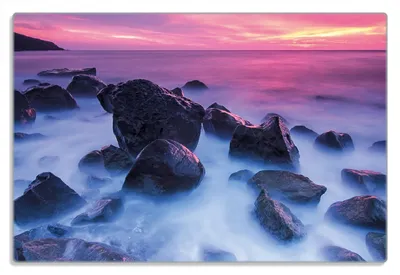 Produktbild von Wallario Frühstücksbrettchen aus Glas 20 x 30 cm mit rutschfesten Füßen, Motiv Felsen im Meer bei Sonnenuntergang