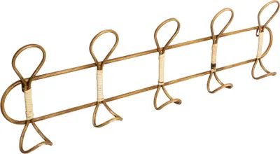 A gold-colored metal coat rack with five hooks against a white background.