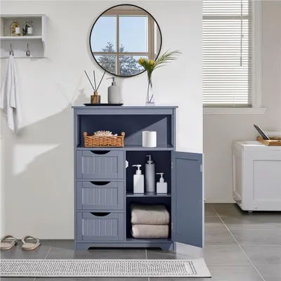 A bathroom cabinet with drawers and an open door, displaying toiletries and towels.
