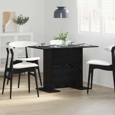 A dining table set in a room with a cabinet and window.