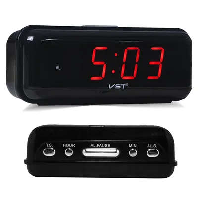 A black digital alarm clock with a red LED display and buttons on the bottom.