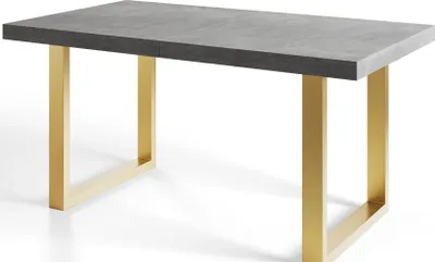A dining table with a gray top and gold metal legs, shown against a white background.