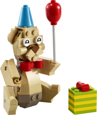 A Lego teddy bear with a party hat and balloon, next to a small Lego gift box.