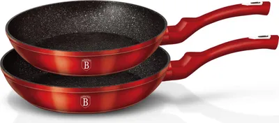 Two red frying pans stacked on a white background.