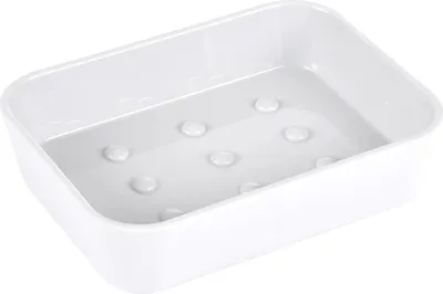 A white ceramic soap dish with raised bumps on the inside bottom.