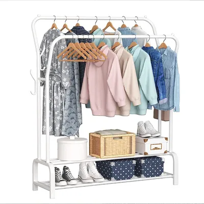 A white metal garment rack with clothes, shoes, and storage boxes.