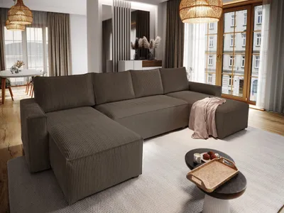 A modern living room with a large sectional sofa, coffee table, and dining area visible in the background.