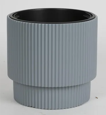 A gray ribbed planter with a black inner pot against a white background.