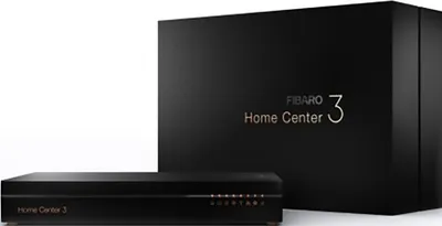 A black Fibaro Home Center 3 smart home hub is shown in front of its black packaging box.