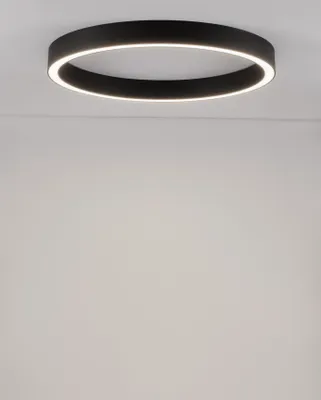 A modern, circular ceiling light fixture is mounted on a white ceiling.