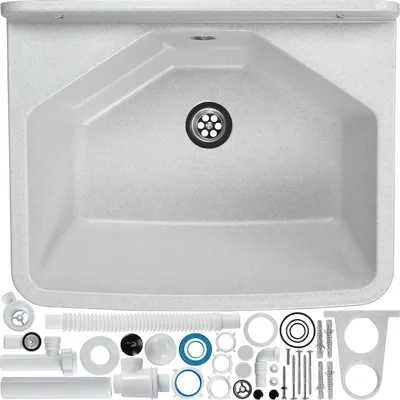 A white sink with a drain and various plumbing accessories laid out below it.