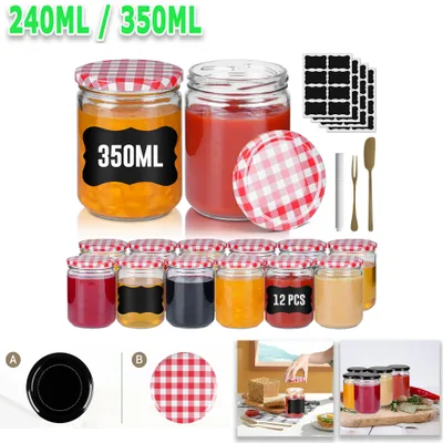 A collection of glass jars with red and white checkered lids, some filled with colorful contents and others empty, along with accessories like labels and a small fork and spatula.