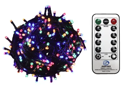 A tangled ball of multicolor LED string lights next to a remote control.