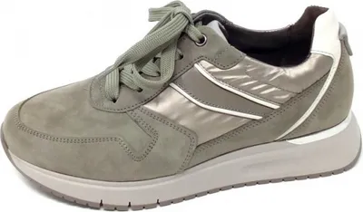 A single green women's sneaker is shown against a white background.
