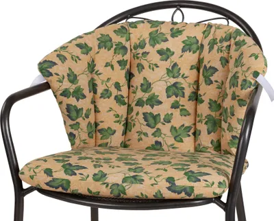 A close-up shot of a chair cushion with a leaf pattern.