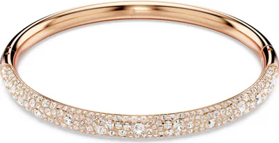 A close-up studio shot of a rose gold bracelet adorned with clear crystals.