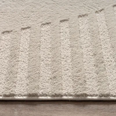 A close-up view of a textured rug with a geometric pattern.