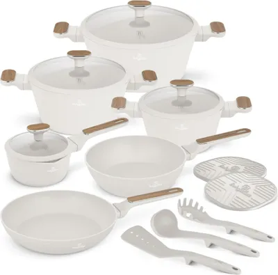 A collection of white cookware and kitchen utensils arranged on a white background.