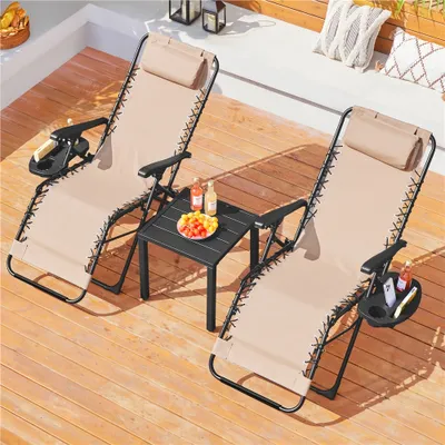 Two beige lounge chairs and a small black table on a wooden deck.