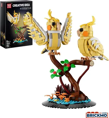 A LEGO-style building block model of two cockatiels perched on a tree branch, with a box of the product in the background.