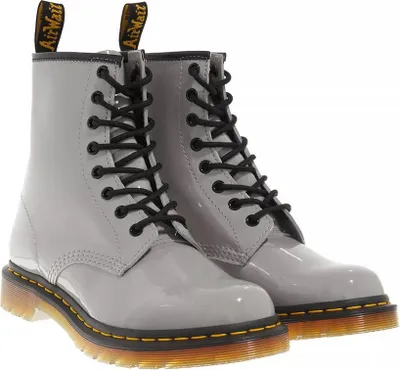 A pair of gray patent leather Dr. Martens boots.
