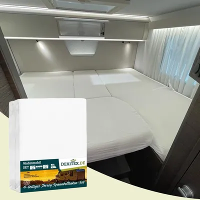 A bed in a recreational vehicle (RV) with white bedding, and a product package in the foreground.