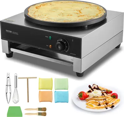 A VEVOR electric crepe maker with a crepe on the hot plate, along with various accessories and a plate of crepes with strawberries and whipped cream.