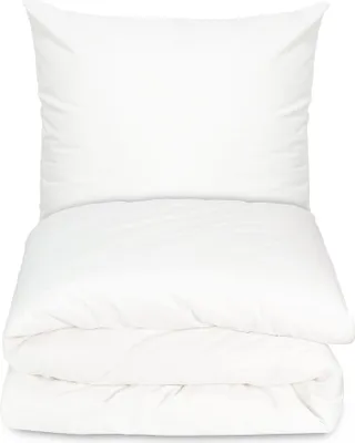 A white pillow and a folded white duvet are stacked on top of each other against a white background.