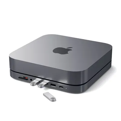 A Satechi Aluminium Hub Cradle for Mac Mini is shown on a white background with USB drives plugged in.