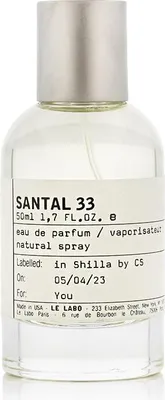 A clear studio shot of a Le Labo Santal 33 perfume bottle.