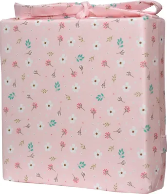 A pink cushion with a floral pattern and a bow on top, presented on a white background.
