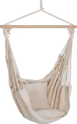 A beige hammock chair with two cushions hanging from a wooden bar.