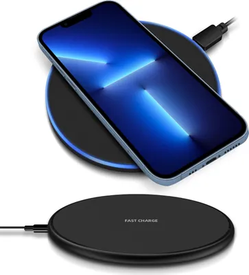 A smartphone is charging on a wireless charging pad.