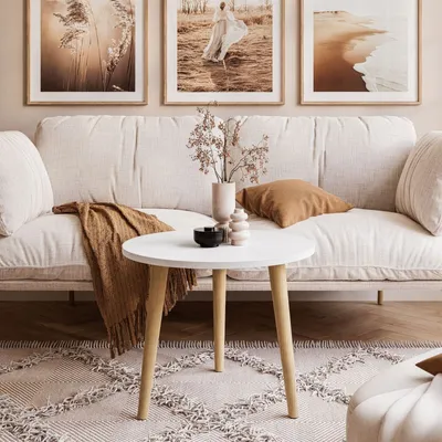 A living room scene with a couch, coffee table, and artwork.