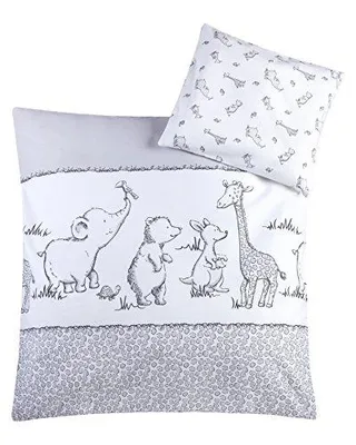 A bedding set with a pillow and duvet cover featuring cartoon animals.