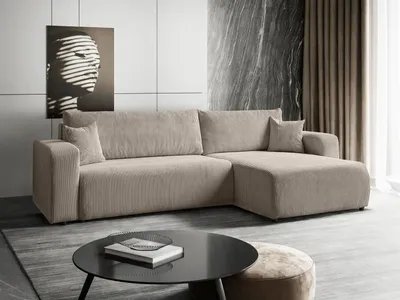 A modern living room setting with a sectional sofa, coffee table, and artwork.