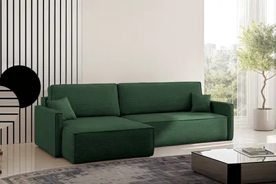A green sectional sofa with a chaise lounge in a modern living room setting.