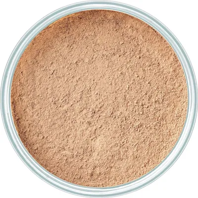 A top-down view of loose mineral powder foundation in a container.