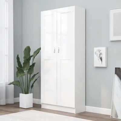 A white cabinet is shown in a room with a plant and artwork on the wall.