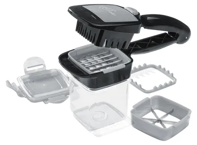A disassembled vegetable chopper with multiple attachments is shown against a white background.