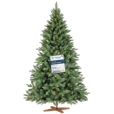 A full shot of an artificial Christmas tree with a tag attached.