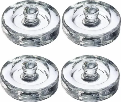Four clear glass fermentation weights are arranged in a two-by-two grid on a white background.