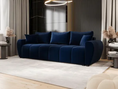 A modern living room with a dark blue velvet sofa as the main focal point.